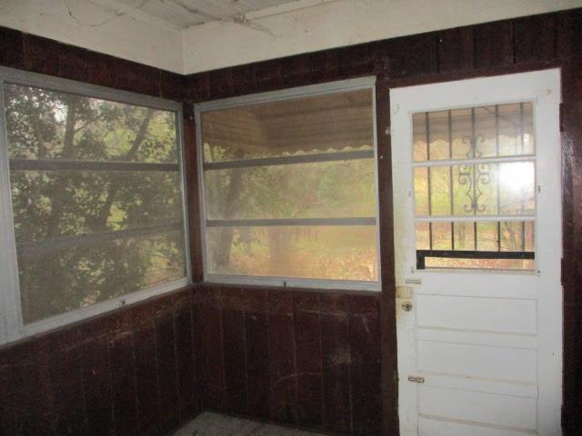 unfurnished sunroom with plenty of natural light