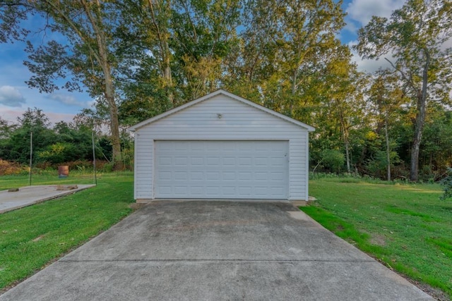 garage at dusk featuring a yard