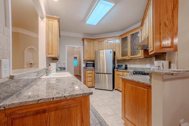 kitchen with crown molding, sink, appliances with stainless steel finishes, light stone counters, and kitchen peninsula