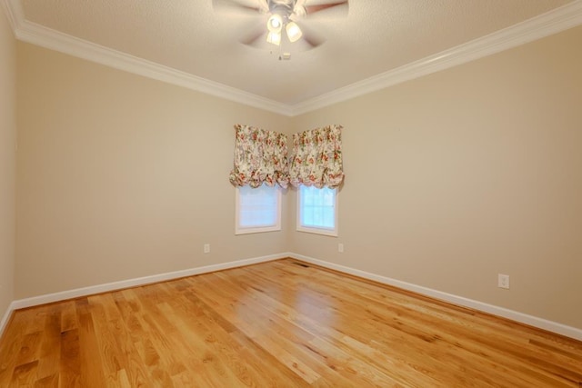 empty room featuring hardwood / wood-style floors, ceiling fan, and crown molding