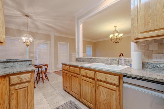 kitchen featuring pendant lighting, sink, stainless steel dishwasher, and an inviting chandelier