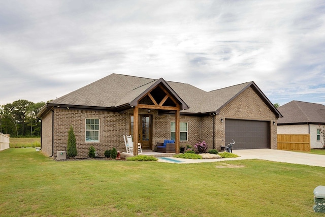 view of front of property featuring a front yard and a garage