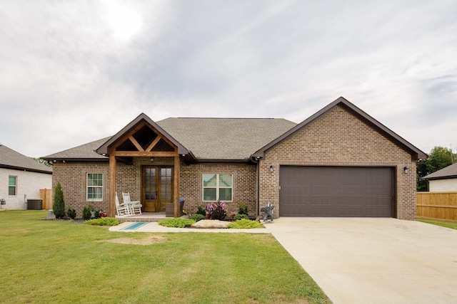 view of front of property featuring a front lawn, central AC unit, a garage, and french doors