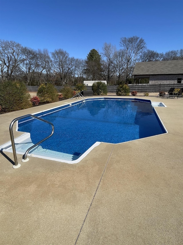 view of pool featuring a patio area, fence, and a fenced in pool