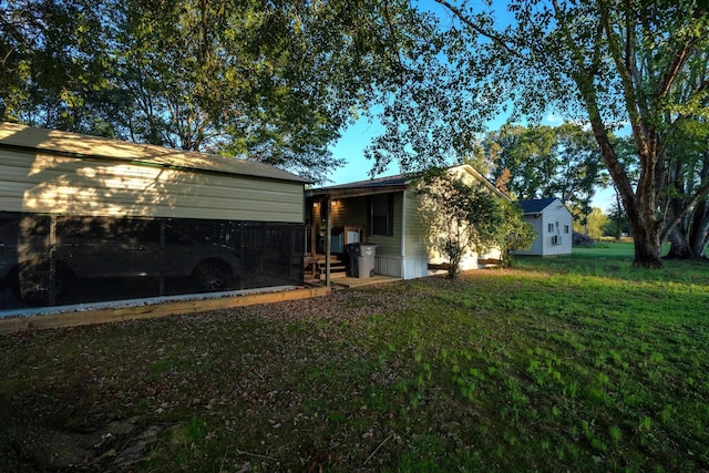 exterior space featuring a yard and a carport