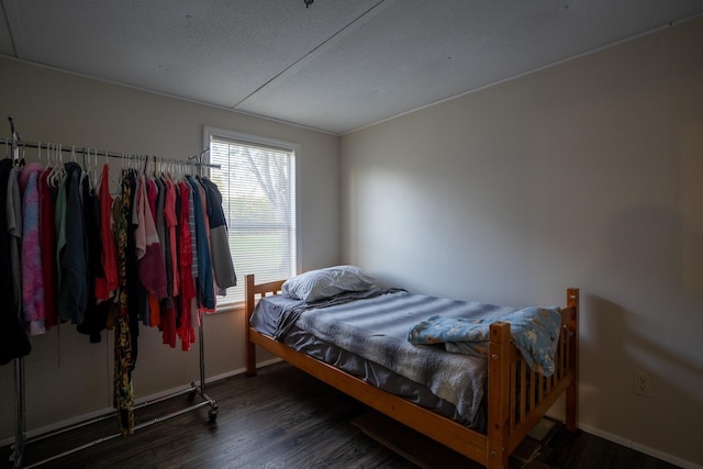 bedroom featuring dark hardwood / wood-style floors and a textured ceiling