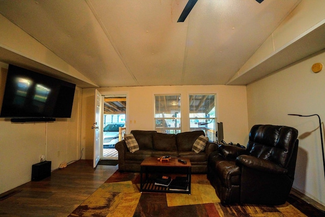 living room featuring vaulted ceiling and dark wood-type flooring