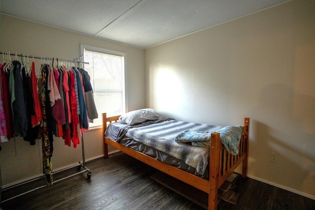 bedroom featuring dark hardwood / wood-style flooring