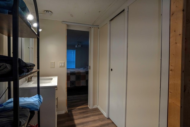 hallway featuring dark wood-type flooring and sink