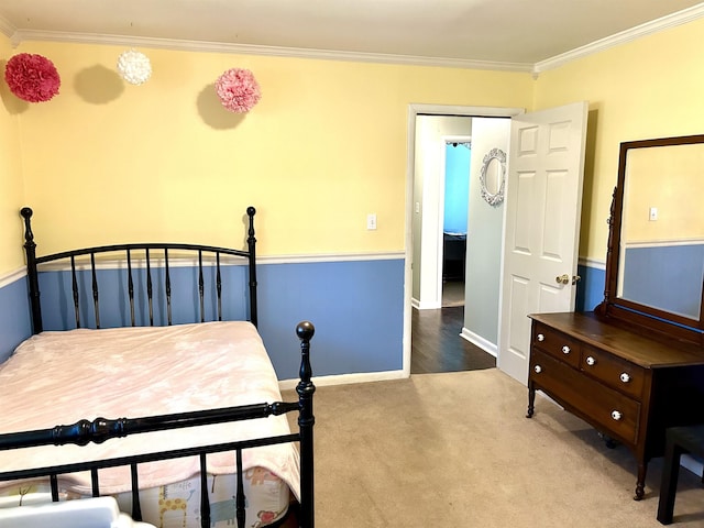 bedroom featuring baseboards, ornamental molding, and carpet flooring