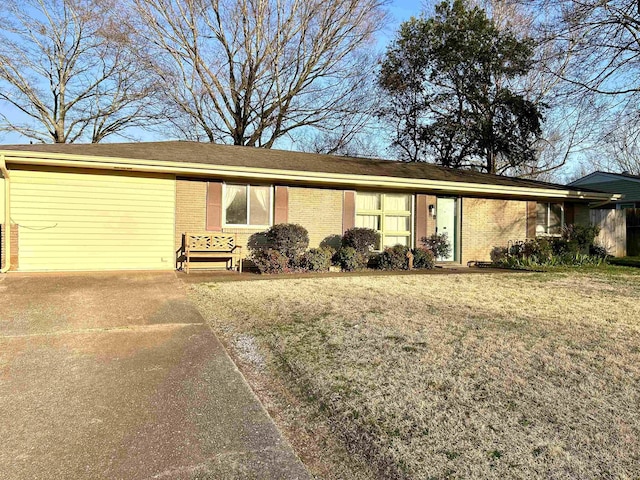 ranch-style house featuring brick siding and a front yard