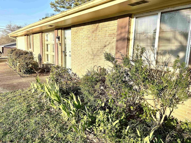 view of property exterior with brick siding