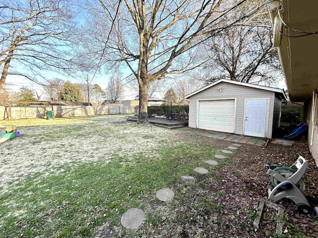 view of yard with an outdoor structure, a playground, fence private yard, and a garage