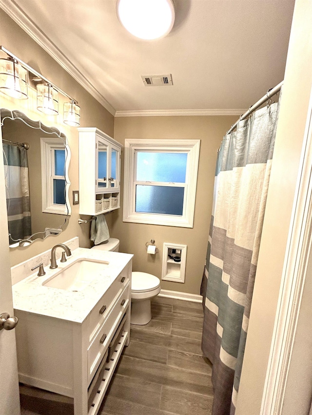 full bath featuring visible vents, toilet, ornamental molding, wood finished floors, and vanity