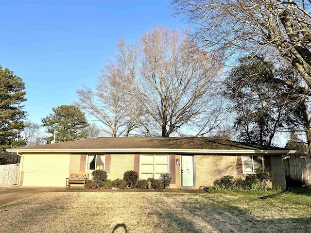 ranch-style home with a front yard, fence, and brick siding