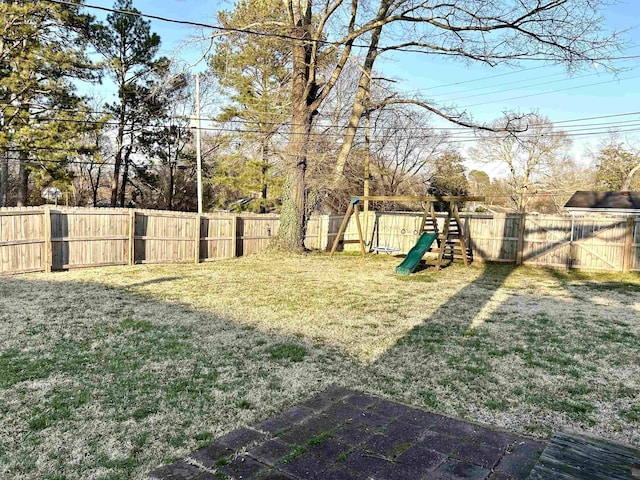 view of yard featuring a fenced backyard and a playground