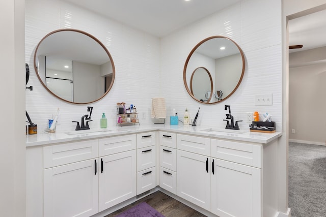 bathroom featuring vanity and tasteful backsplash