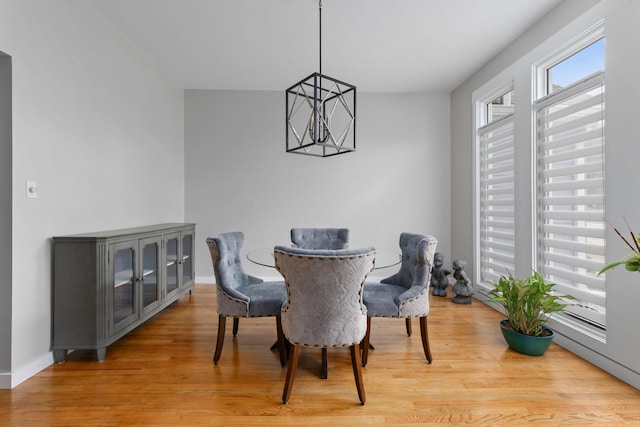 dining room featuring hardwood / wood-style floors and a chandelier