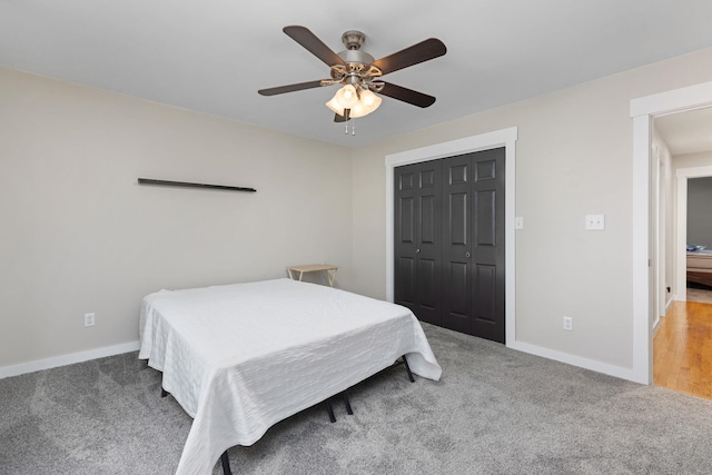 carpeted bedroom featuring a closet and ceiling fan