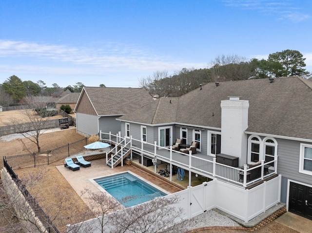 view of pool with a wooden deck, outdoor lounge area, a jacuzzi, and a patio area