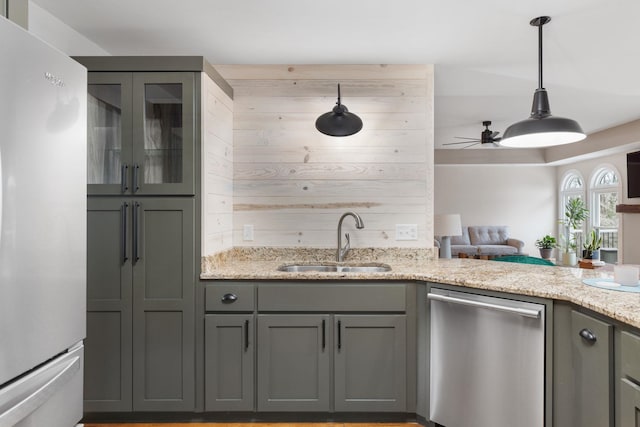 kitchen with sink, gray cabinets, dishwasher, and refrigerator