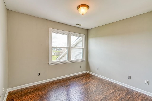 unfurnished room with dark hardwood / wood-style floors