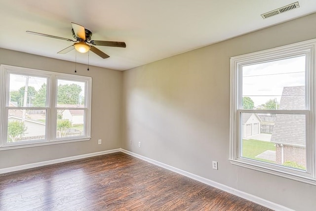 unfurnished room featuring dark hardwood / wood-style floors, a healthy amount of sunlight, and ceiling fan