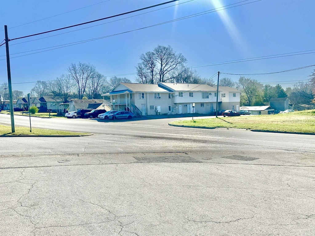  - view of asphalt road featuring a residential view