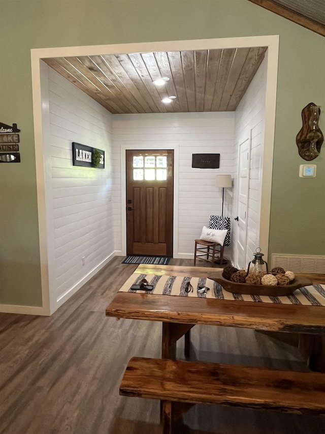 foyer featuring dark wood-type flooring and wood ceiling