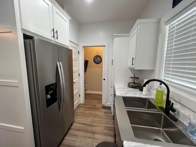 kitchen featuring stainless steel fridge with ice dispenser, dark hardwood / wood-style floors, sink, and white cabinets