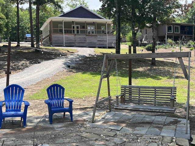 view of front of property with covered porch and a front lawn