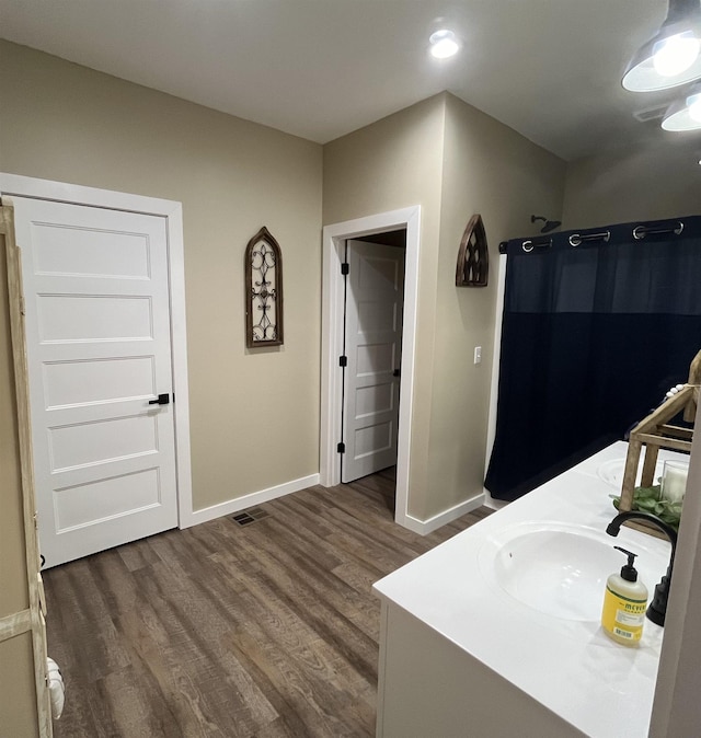 bathroom featuring vanity and hardwood / wood-style floors