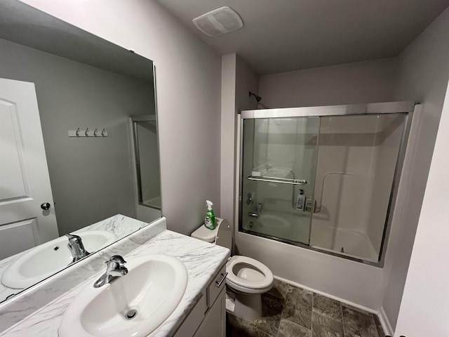 full bathroom featuring vanity, toilet, and shower / bath combination with glass door