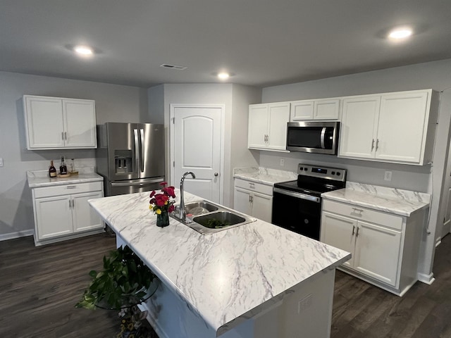 kitchen with a kitchen island with sink, white cabinetry, sink, and appliances with stainless steel finishes