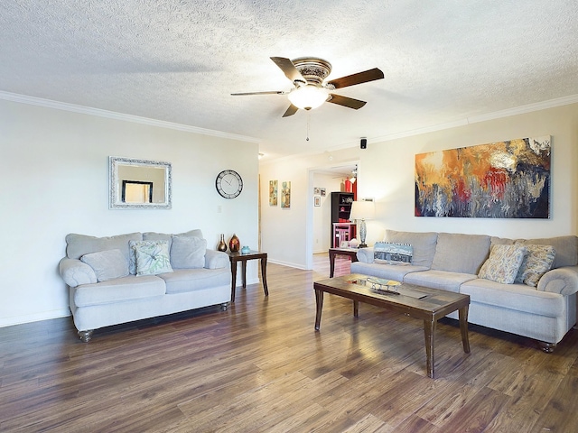 living area featuring a ceiling fan, a textured ceiling, ornamental molding, and wood finished floors