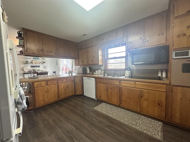  - kitchen with black appliances, a sink, and dark wood-type flooring