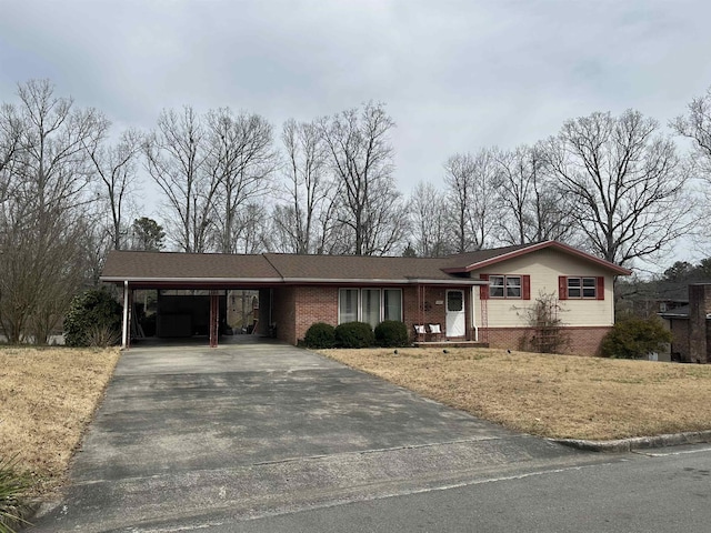 view of front facade with driveway, an attached carport, and brick siding