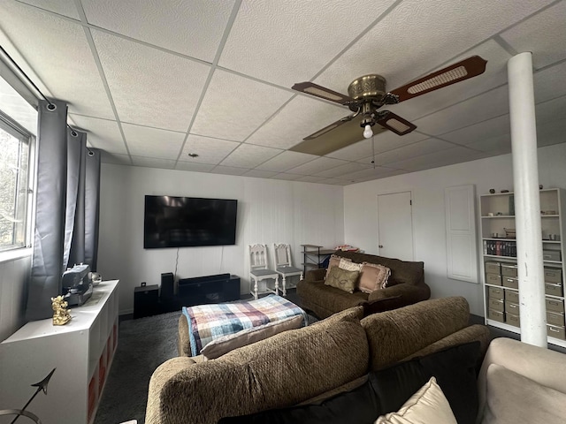  - carpeted living room with a ceiling fan and a paneled ceiling