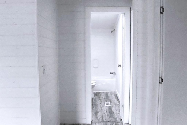 bathroom featuring hardwood / wood-style flooring and toilet