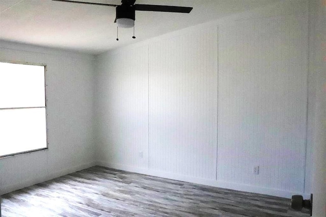 empty room featuring ceiling fan and dark hardwood / wood-style floors