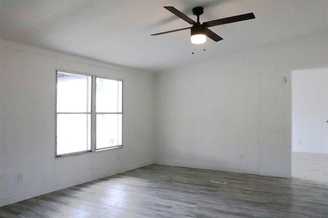 spare room with ceiling fan and dark hardwood / wood-style floors