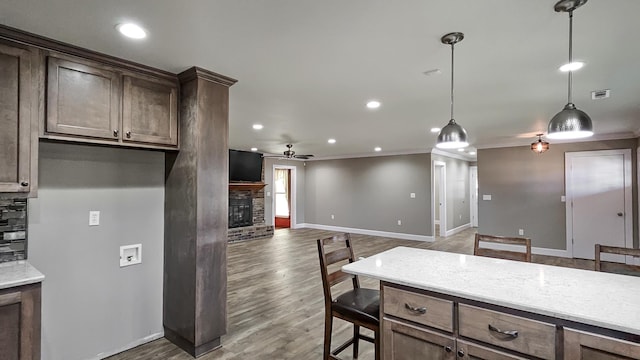 unfurnished living room featuring ceiling fan, hardwood / wood-style floors, and crown molding