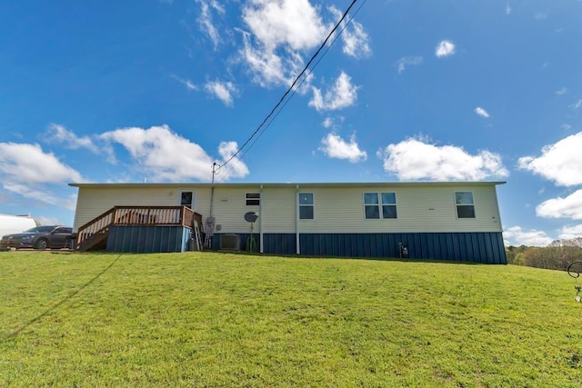 rear view of house featuring a yard, cooling unit, and a deck