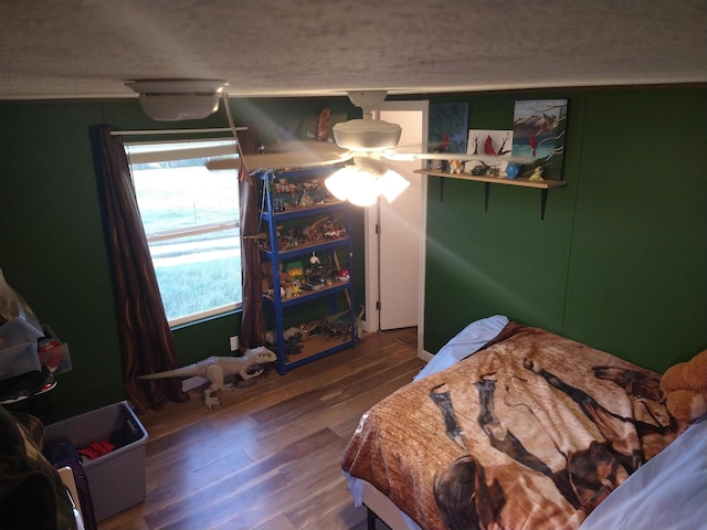 bedroom with ceiling fan and wood-type flooring