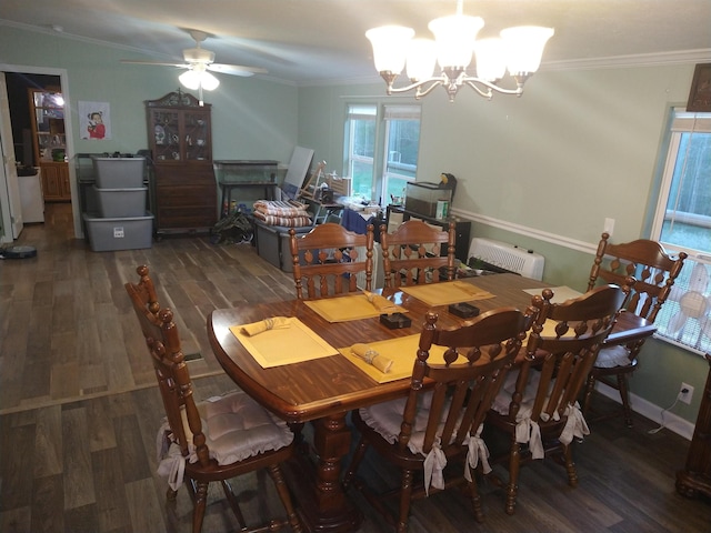 dining space featuring crown molding, dark wood-type flooring, and ceiling fan with notable chandelier