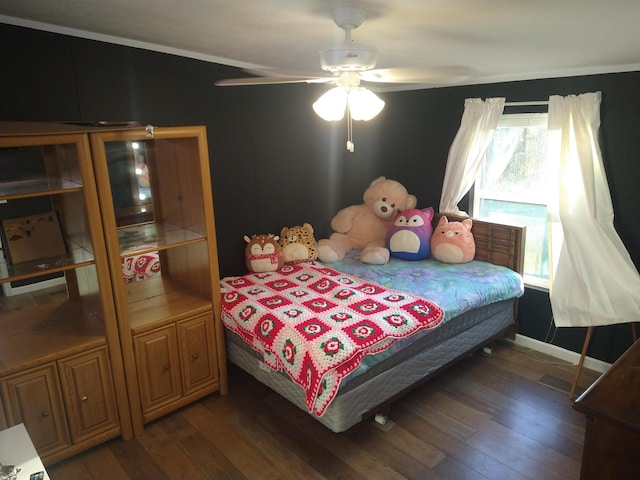 bedroom with dark hardwood / wood-style floors and ceiling fan