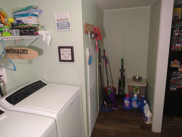 clothes washing area with dark hardwood / wood-style floors and washing machine and dryer