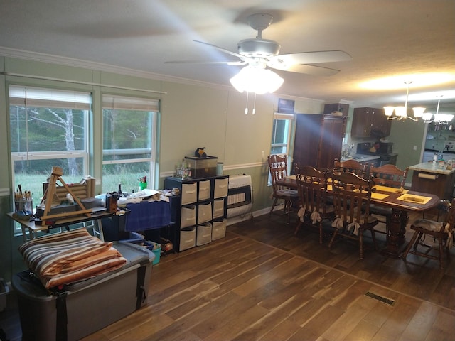 dining area with dark hardwood / wood-style flooring, ceiling fan with notable chandelier, and ornamental molding