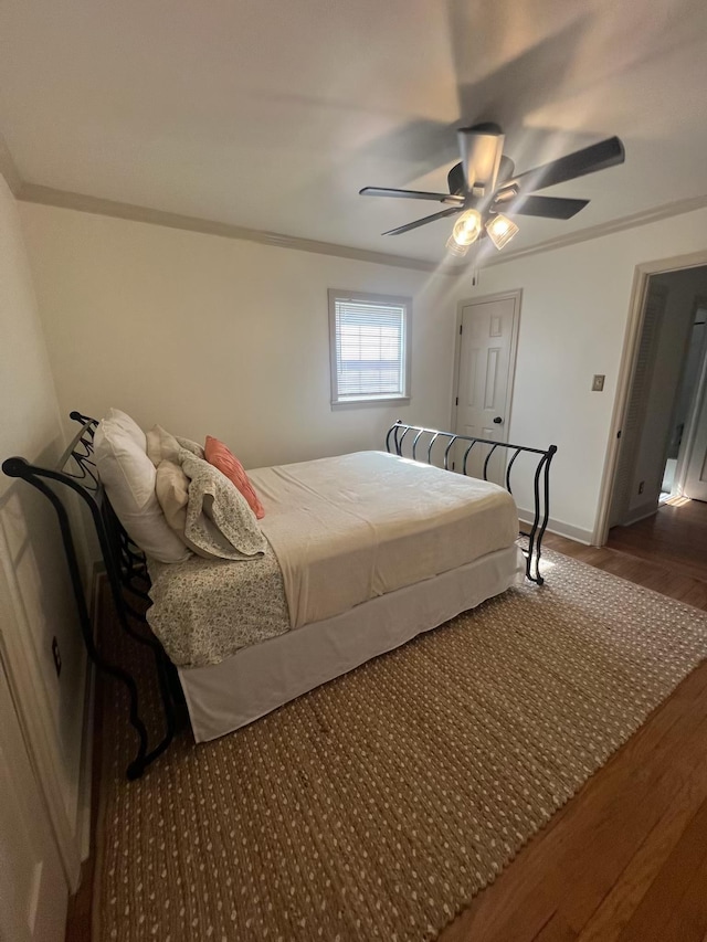  - bedroom with wood finished floors, crown molding, ceiling fan, and baseboards