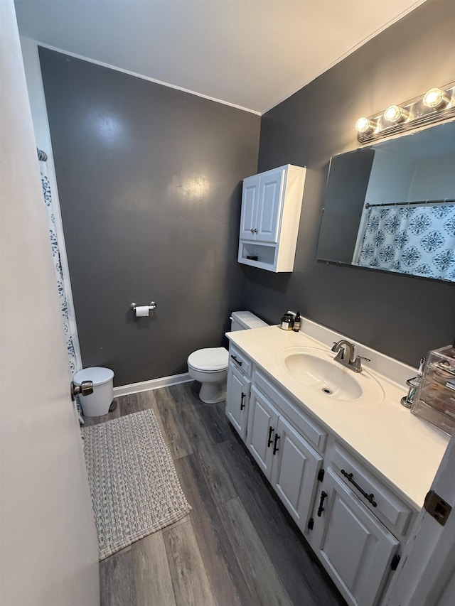  - bathroom with toilet, wood finished floors, and vanity
